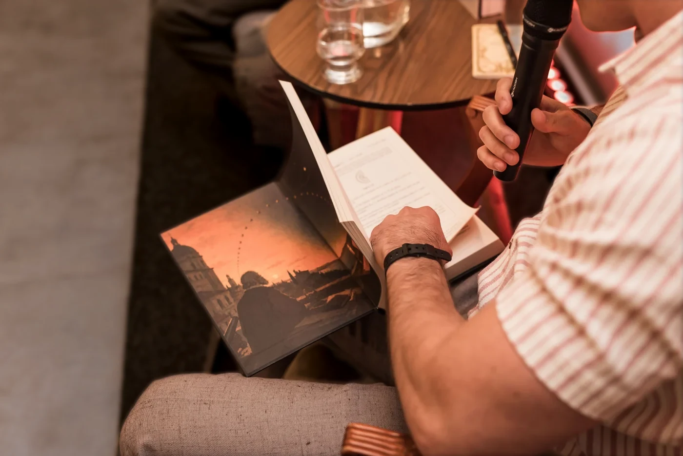 Leitor folheando o miolo do livro durante o lançamento